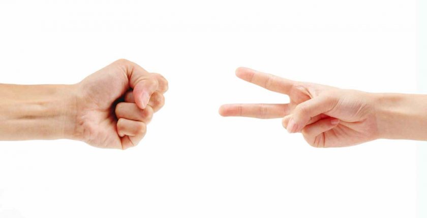 Two people playing rock, paper, scissors.