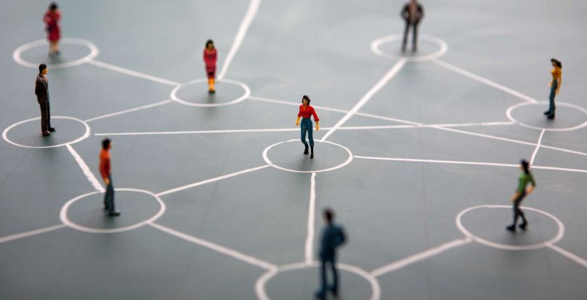 Miniature people connected by lines