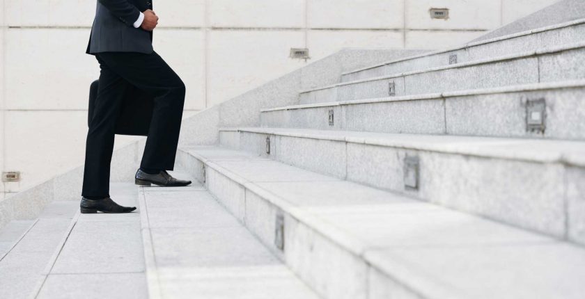 Cropped image of businessman walking up the stairs